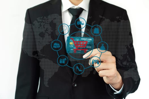 Elegant customer wear black suit and tie hold credit card, cashless technology, by left hand. Smart consumer use hologram graphic interface of e-commerce application platform around hands. Cybercash.