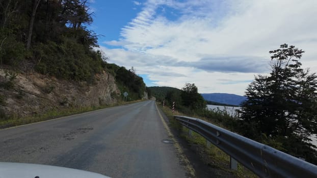 Exploring Patagonia: A blue lake flanks the road, creating scenic drives.