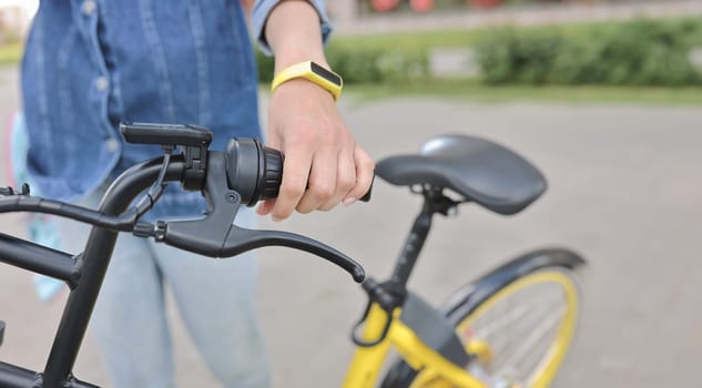 Healthy lifestyle. Woman hold handlebars of bicycle close up. Rent and hire of sports equipment.