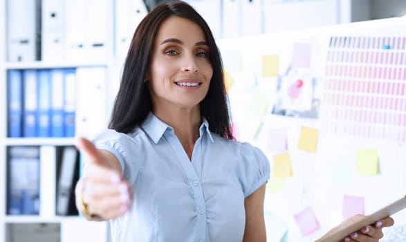 Beautiful smiling female clerk offering arm to client or interview visitor introducing herself closeup. Friend thanks for friendly support giving motivation for future