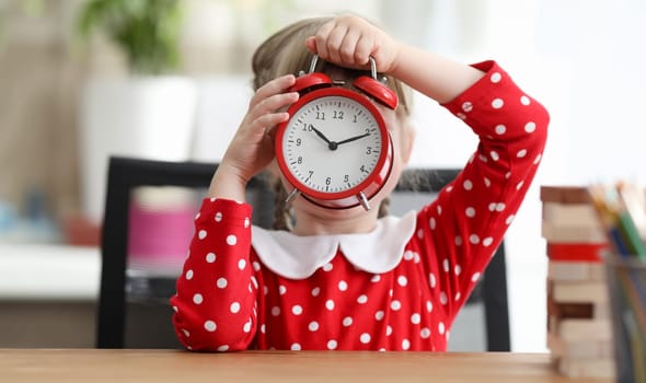 Baby dress covered her face with large alarm clock. Get to know numbers and numbers on watch. Difference between mechanical watch and an electronic one. Practical tasks games clock