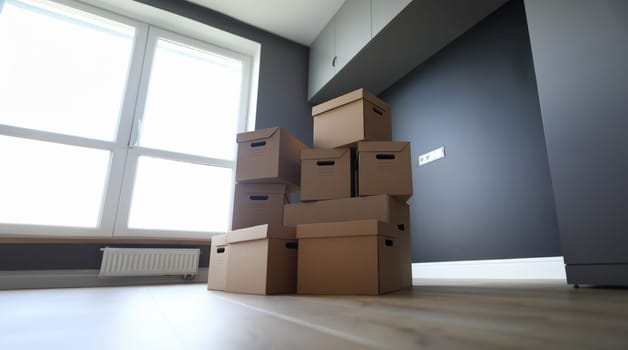 Lot of cardboard boxes on wooden floor new flat closeup background. Fast banking credit concept