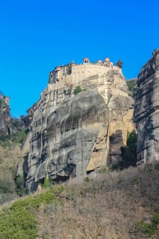 Experience the awe-inspiring beauty of the church nestled atop a cliff in Meteora, Greece, a testament to human ingenuity and spiritual devotion