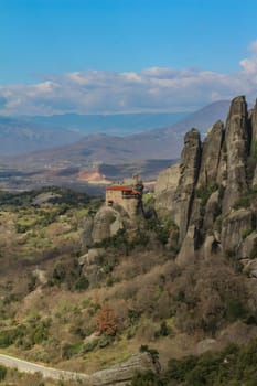 Discover serenity amidst the grandeur of Meteora's towering cliffs, where the smallest of churches offers a tranquil retreat amidst breathtaking natural beauty