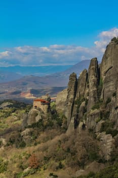 Discover serenity amidst the grandeur of Meteora's towering cliffs, where the smallest of churches offers a tranquil retreat amidst breathtaking natural beauty