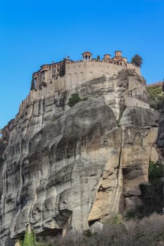 Experience the awe-inspiring beauty of the church nestled atop a cliff in Meteora, Greece, a testament to human ingenuity and spiritual devotion