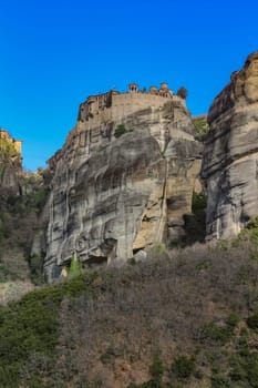 Experience the awe-inspiring beauty of the church nestled atop a cliff in Meteora, Greece, a testament to human ingenuity and spiritual devotion