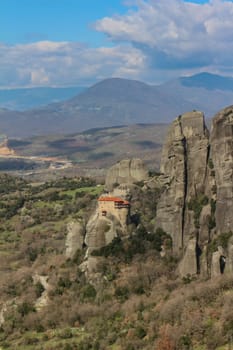 Discover serenity amidst the grandeur of Meteora's towering cliffs, where the smallest of churches offers a tranquil retreat amidst breathtaking natural beauty