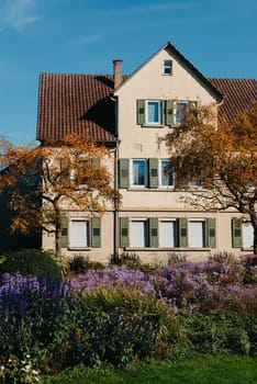 House with nice garden in fall. Flowers in the Park. Bietigheim-Bissingen. Germany, Europe. Autumn Park and house, nobody, bush and grenery