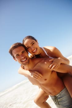 Vacation, portrait and couple piggy back at the beach with love, hug and support together on holiday in summer. Laugh, sea and happy with smile and bonding by water with travel in Miami with people.