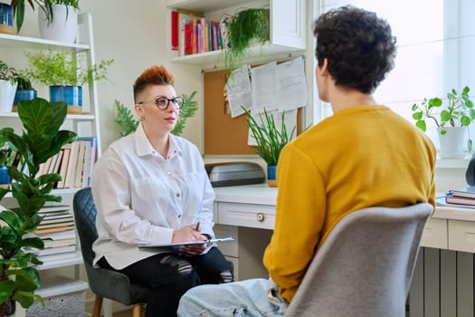 Female professional psychologist mental therapist working with young guy in office. Social worker counselor psychotherapist helping patient with difficulties stress depression. Psychology psychotherapy