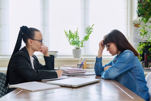 Mental therapy session of sad unhappy depressed stressed mature female with professional psychologist counselor. Talking serious women sitting at table, psychology psychotherapy support help treatment