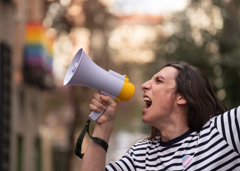 Transgender woman is holding a megaphone and yelling to protest for homosexual social discrimination.