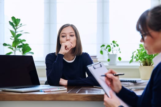 Sad unhappy young woman patient at session with female psychologist therapist social worker counselor psychotherapist. Mental health professional support treatment, feelings stress depression trauma