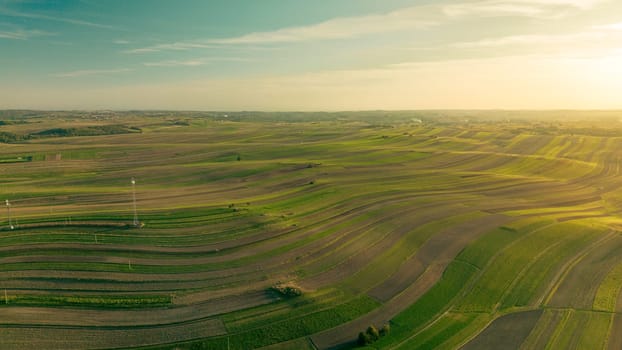 Agricultural fields to horizon at sunset, aerial view of Suloszowa village land in Krakow County, Poland