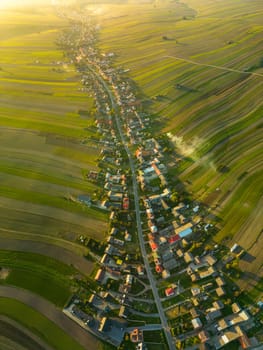 Aerial drone photo of houses along road in Suloszowa village in day sunlight, Krakow County, Poland