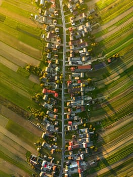 Aerial view directly from above on countryside cultivated green fields and farmers houses of Suloszowa village in Krakow County, Poland