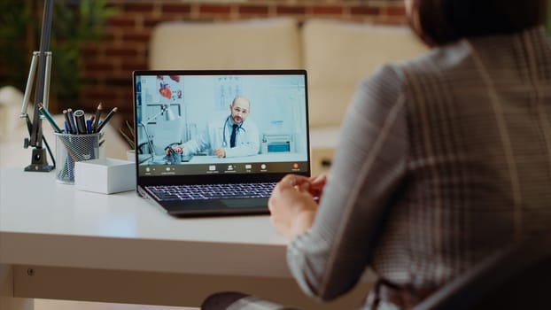 Remotely working employee in telemedicine video call asking for medical advice, feeling sick. Teleworker in online consultation checkup with doctor, receiving prescription plan, camera B