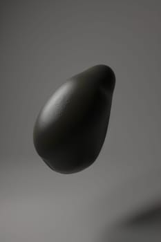 a dark grey stone object floating in the air, 3d presentation, Generative AI.