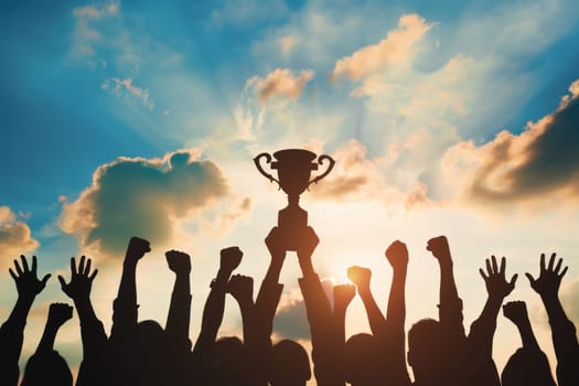 A group of people are holding up a trophy in the air.