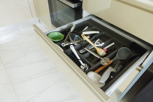 Close up of messy kitchen utensil drawer