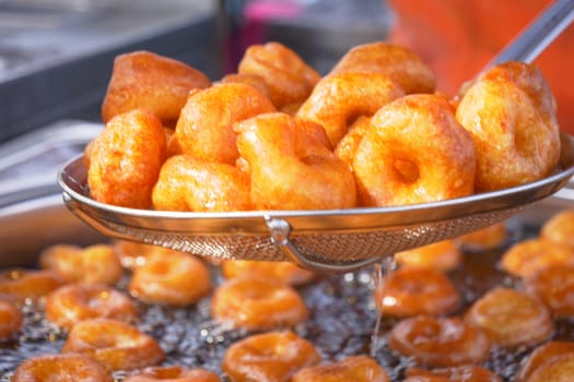 Traditional fried sweets lokma in sugar syrup.