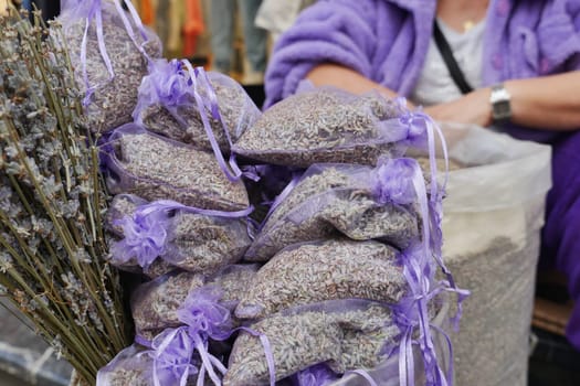 A stack of purple lavender bags fills the basket, creating a beautiful pattern,