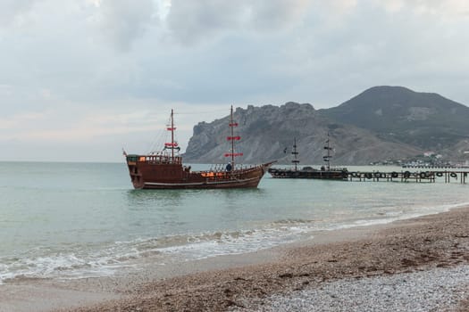 Sailing ship sailing to the shore, marine tourism. Beach holidays on the Black Sea. Fabulous moments of a sunny day