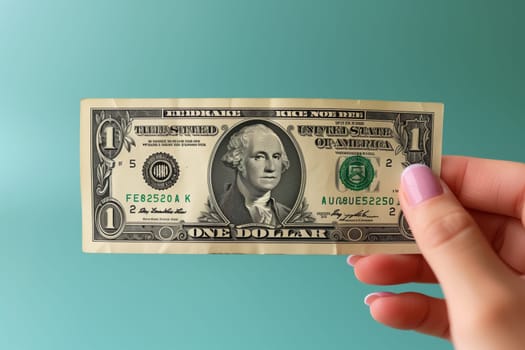 The person is holding a collectable banknote in their hand. The paper product features a line design and is being held between their finger and thumb, showcasing their money handling skills