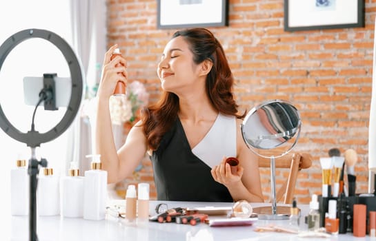 Woman influencer shoot live streaming vlog video review makeup uttermost social media or blog. Happy young girl with cosmetics studio lighting for marketing recording session broadcasting online.