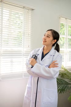Confident female doctor Smiling woman standing holding stethoscope in clinic.