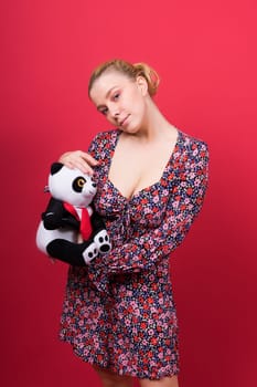 Portrait of seductive woman posing in a studio with panda