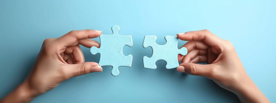 a person is holding two puzzle pieces together on a blue background . High quality