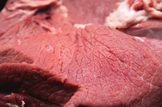 Close-up of a piece of fresh beef meat in shallow depth of field.