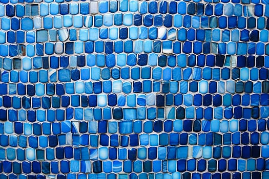 A blue mosaic tile wall with a blue and white swirl pattern. The tiles are blue and white and are arranged in a way that creates a sense of movement and depth