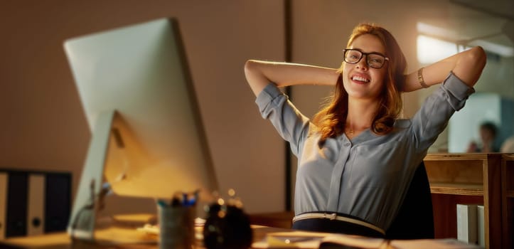 Woman, employee and relax in office with computer on work break for overtime or deadline at night. Female person, portrait and worker with smile as administrator for administration and arms on head.