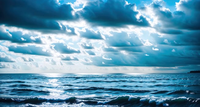 The image shows a large body of water with waves crashing against the shore, with a clear blue sky above.