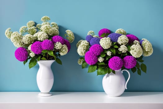 The image shows two vases filled with white and pink flowers on a blue wall.