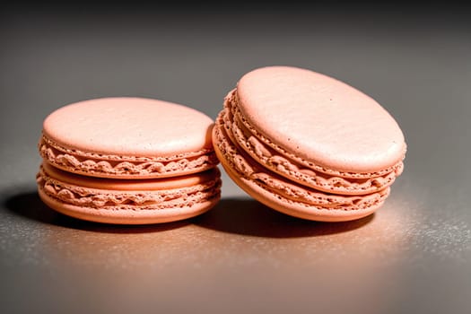 The image shows two pink macarons on a white background.