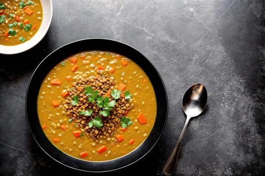 The image shows a bowl of vegetable soup with carrots, potatoes, and parsley on the side.