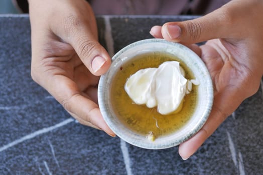 butter cream and honey in a bowl on table