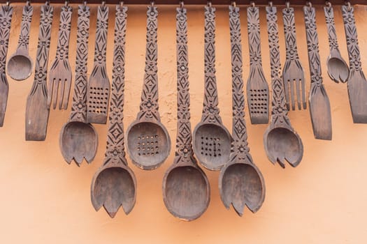 A collection of decorative large wooden spoons adds a touch of Mexican charm to an outdoor space, showcasing traditional craftsmanship and cultural motifs.