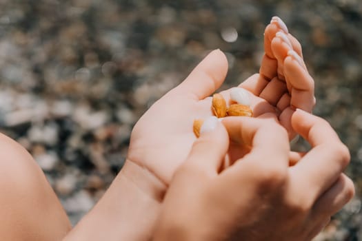 Woman eating milky almond nuts. A young caucasian woman choping fresh green almond after morning fitness yoga near sea. Only hands are visibly. Healthy vegan food. Slow motion. Close up