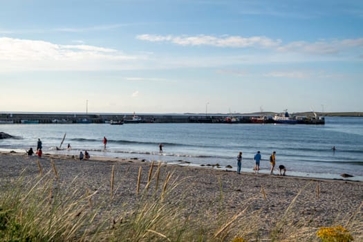 MAGHEROARTY, IRELAND - JULY 31 2022: Holiday makers enjoying the are.