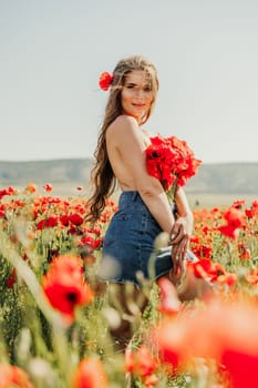 Woman poppies field. portrait of a happy woman with long hair in a poppy field and enjoying the beauty of nature in a warm summer day