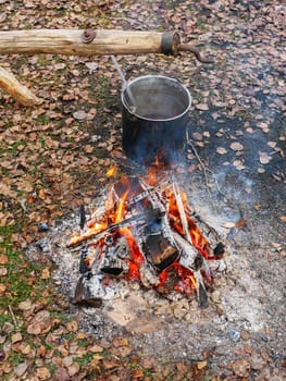 cauldron with food near the fire. Camping kettle. camping kitchen. .traveling kitchen