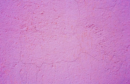 Old peeling paint on the wall. purple abstract background...Background from purple stucco.