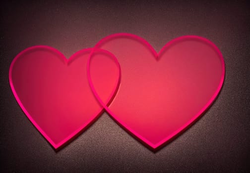 The image is a pink heart shape with two hearts inside it, one on top of the other.