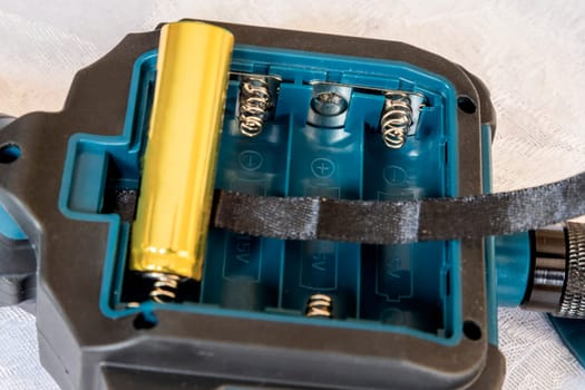 putting new batteries in a device or replacement