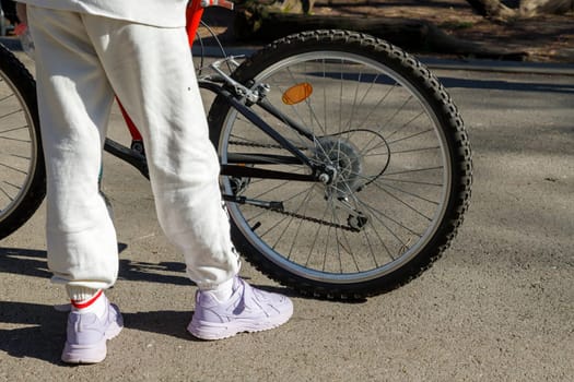 Cyclist waiting with bike in the garden, concept of freedom and sport in nature